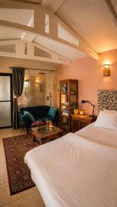 a bedroom with a bed and a living room at MARRAKECH פלא - PELEH - Queit place 3 km from the beach of Cesarea in Or ‘Aqīvāh