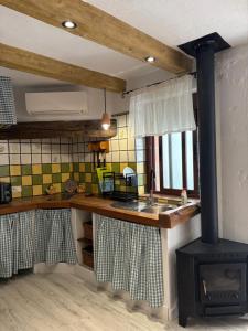 a kitchen with a stove in the middle of a kitchen at Las Casitas de mi Abuela in Casares