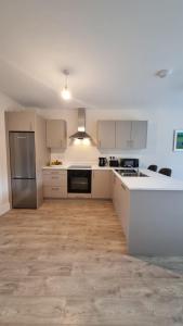 an empty kitchen with white cabinets and appliances at Lidia House in Westport