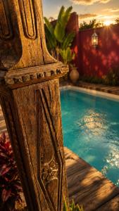 a wooden bench next to a swimming pool at פלא - PELEH -KASHMIR -Quiet place 3 km from caesarea beach in Or ‘Aqīvāh