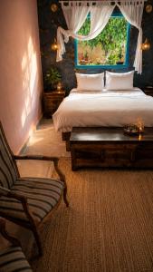 a bedroom with a bed and a chair and a window at פלא - PELEH -KASHMIR -Quiet place 3 km from caesarea beach in Or ‘Aqīvāh +103 photos