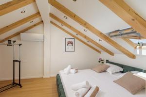 a bedroom with a white bed in a attic at Luxury room Sunset Cavtat in Cavtat