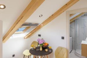 a kitchen with a table and chairs in a attic at Luxury room Sunset Cavtat in Cavtat