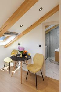 a dining room with a table and two chairs at Luxury room Sunset Cavtat in Cavtat +6 photos