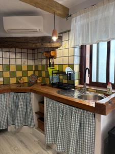 a kitchen with a sink and a counter at Las Casitas de mi Abuela in Casares