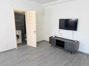 a living room with a flat screen tv on a wall at Beni Apartman in Szeged
