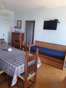 a bedroom with a table and a bed and a television at Casa vacanze levanzo in Levanzo
