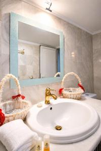 a bathroom with a sink and a mirror at Aias Summer House in Aiándion +28 photos