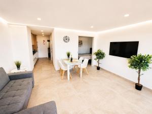 a living room with a couch and a table at Luxury Ocean View Apartments I Sunset Terrace I Pool I 200m to Praia dos Três Castelos in Portimão +40 photos