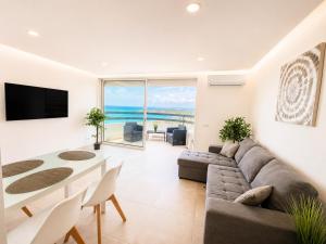 a living room with a couch and a table at Luxury Ocean View Apartments I Sunset Terrace I Pool I 200m to Praia dos Três Castelos in Portimão