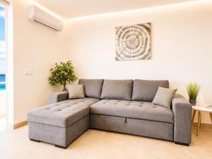 a living room with a couch and a table at Luxury Ocean View Apartments I Sunset Terrace I Pool I 200m to Praia dos Três Castelos in Portimão