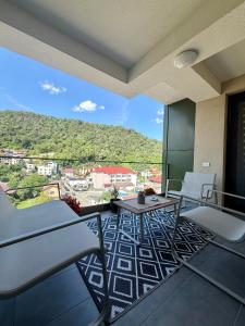a room with chairs and tables on a balcony at ND Central Apartment in Râmnicu Vâlcea