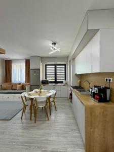 a kitchen and dining room with a table and chairs at ND Central Apartment in Râmnicu Vâlcea