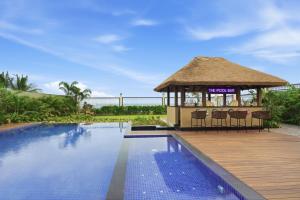 a gazebo next to a swimming pool at Amaari Beach Resort in Kanyakumari