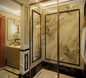 a bathroom with a shower with a marble wall at Locanda Cipriani in Torcello