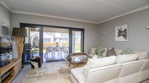 a living room with a couch and a table at My Plett, Your Plett in Plettenberg Bay