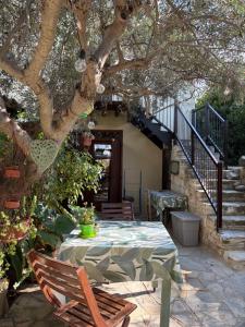 a patio with a table and chairs under a tree at Avli-the courtyard in Nicosia