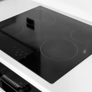 a microwave oven with a black top on a counter at Modern 3 Bed Townhouse - Wolverhampton Centre - Gated Development - Bedroom TV 1CO in Wolverhampton +26 photos