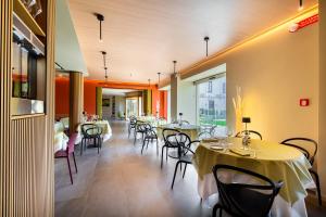 a restaurant with tables and chairs in a room at Villa Neroli - Place of Charme in Florence
