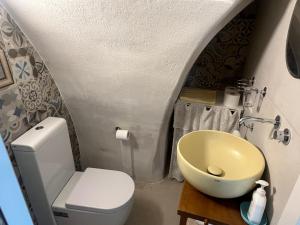 a small bathroom with a toilet and a sink at La Dimora del Gigante in Carovigno +1 photo