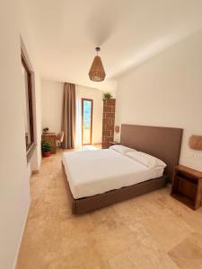 a bedroom with a large bed in a room at Putechella Slow Living Retrait in Tramonti