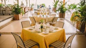 a dining room with tables and chairs with at Hotel Montana in Petionville +20 photos