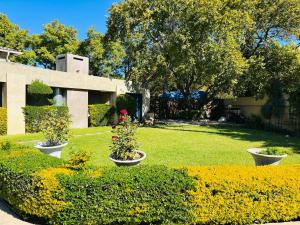 a garden with flowers inront of a building at Guest On 97 in Gaborone