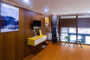 a living room with a desk and a window at Sa Pa Camellia Hotel in Sapa