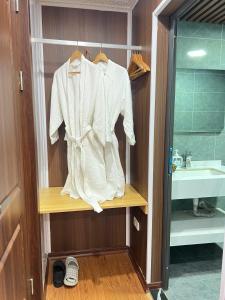 a white jacket on a shelf in a bathroom at Sa Pa Camellia Hotel in Sapa