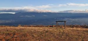 a sign in a field with mountains in the background at Quinta Do Marmeiral in Mangualde