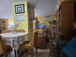 a living room with a table and a couch at Duchniczowe in Prusie