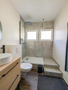 a bathroom with a tub and a toilet and a sink at L'émeraude Waulsort in Waulsort +24 photos