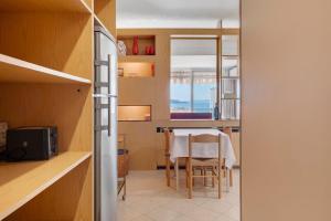 a kitchen and dining room with a table and chairs at Appartamento Vista Lago Ghiffa in Ghiffa