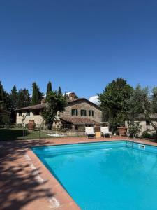 a swimming pool in front of a house at Villa Fioriamo in Greve in Chianti