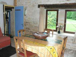 a dining room table with a basket on top of it at Gite de la Maison Noble in Champagné-le-Sec