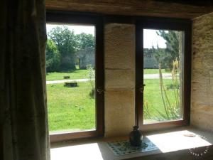 an open window with a view of a field at Gite de la Maison Noble in Champagné-le-Sec +4 photos