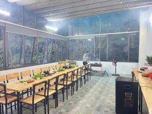 a large room with a long table and chairs at Sa Pa Camellia Hotel in Sapa
