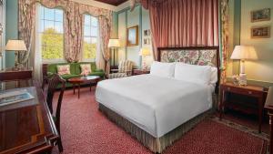 a hotel room with a bed and a living room at The Lanesborough, Oetker Hotels in London
