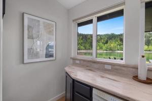a living room with two windows and a wooden counter at Seal Cove in Lilliwaup +40 photos