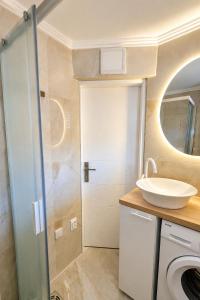 a bathroom with a sink and a washing machine at Danube Panorama House - River View, Jacuzzi & Nature in Čelarevo +14 photos