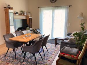 a living room with a wooden table and chairs at Privatroom for rent in Bad Fischau