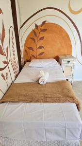 a bed with a towel on top of it at Casa Jasmim in Marau