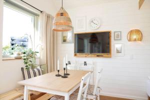 a dining room with a table and a clock on the wall at 13503-Vig-Lyngvej-107-4 in Vig