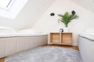 a attic bedroom with a bed and a plant at 13503-Vig-Lyngvej-107-4 in Vig