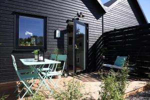 a patio with a table and chairs next to a building at 13503-Vig-Lyngvej-107-4 in Vig