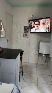 a room with a tv on the wall with at POUSADA MEGA in Marataizes