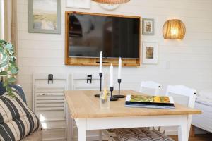 a dining room with a table and a tv at 13502-Vig-Lyngvej-107-3 in Vig