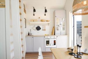 a kitchen with white cabinets and a stove at 13502-Vig-Lyngvej-107-3 in Vig