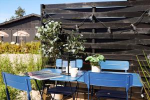 a blue table with two blue chairs in a yard at 13502-Vig-Lyngvej-107-3 in Vig