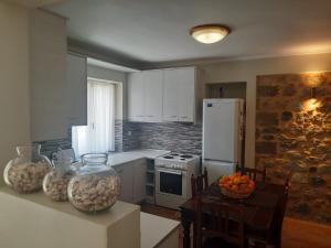 a kitchen with a table with a vase on the counter at Et In Arkadia Ego in Leonidio +20 photos